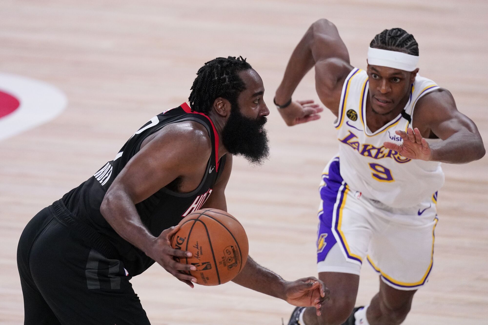 The Rockets' James Harden tries to drive past the Lakers' Rajon Rondo during their playoff series.