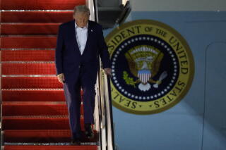 President Trump walks down the stairs of Air Force One