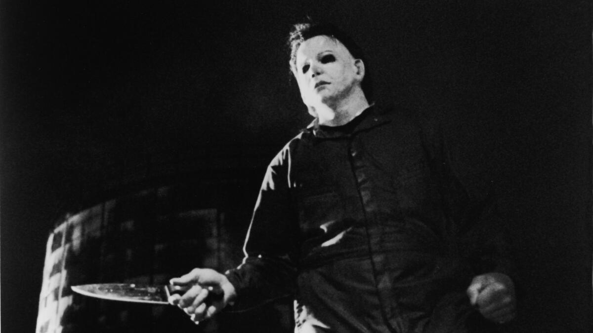 Actor Tony Moran, as masked killer Michael Myers, wields a knife in a still from the horror film "Halloween," directed by John Carpenter.