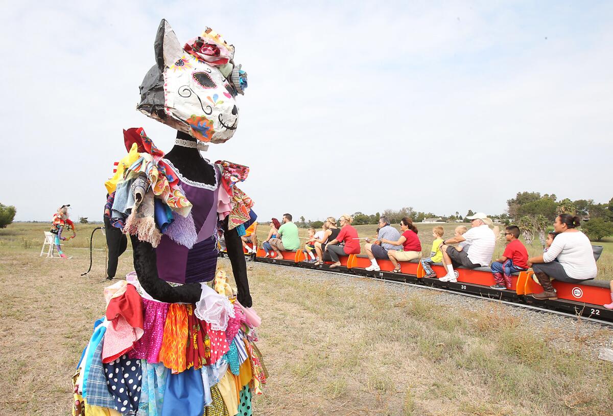 A colorful cat scarecrow was among those displayed during Costa Mesa's Scarecrow and Pumpkin Festival in 2015.