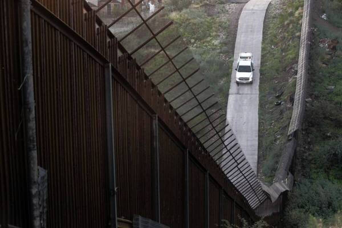 A Border Patrol vehicle near the fence separating Arizona and Mexico.