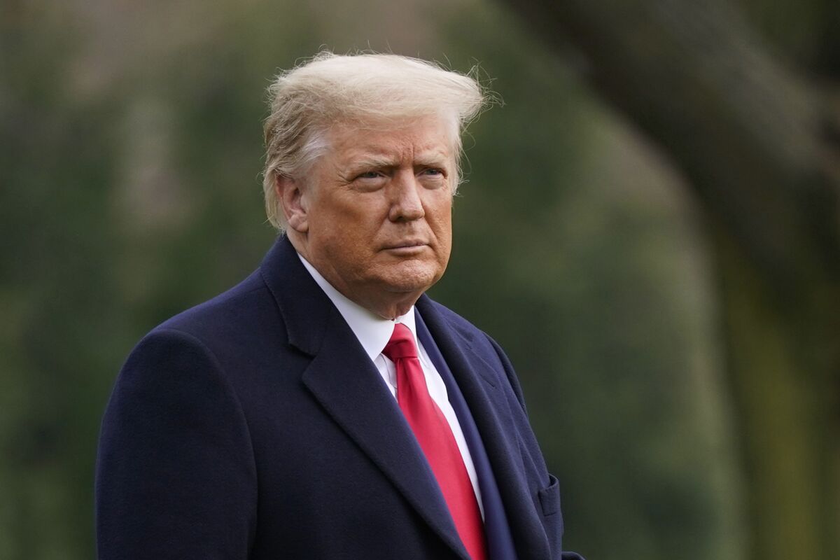 Former President Donald Trump in a blue suit and red tie.