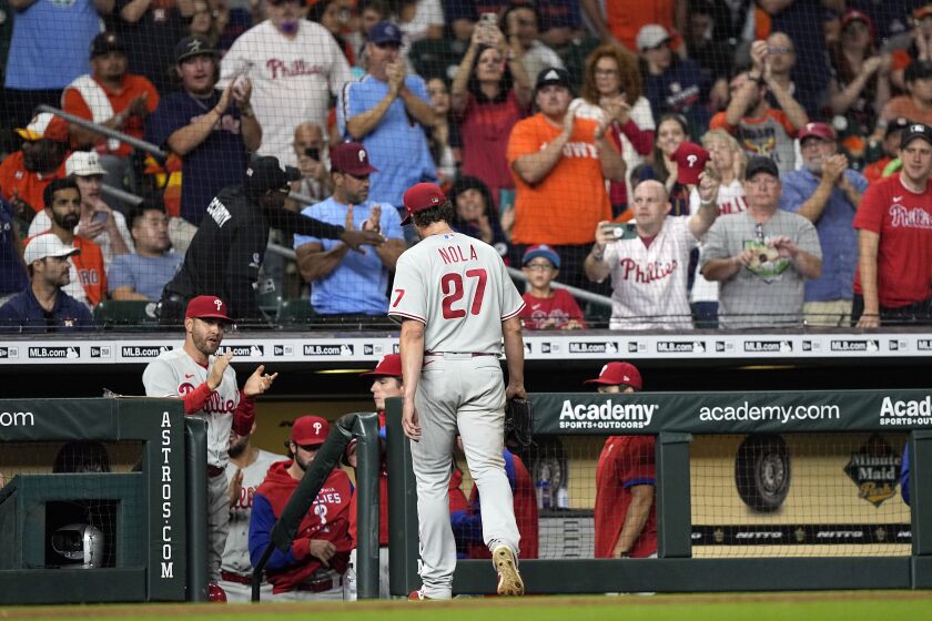 Philadelphia Phillies starting pitcher Aaron Nola (27) walks toward the dugout after being pulled during the seventh inning of a baseball game against the Houston Astros Monday, Oct. 3, 2022, in Houston. (AP Photo/David J. Phillip)