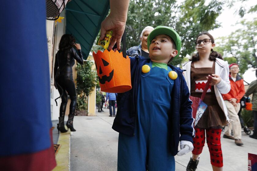 Daniel Nazaryan, 6, of Tujunga, gets a pice of candy at Hearing Science of the Foothills at the Montrose Trick-or-Treat Spooktacular on Honolulu Avenue on Tuesday, October 31, 2017.