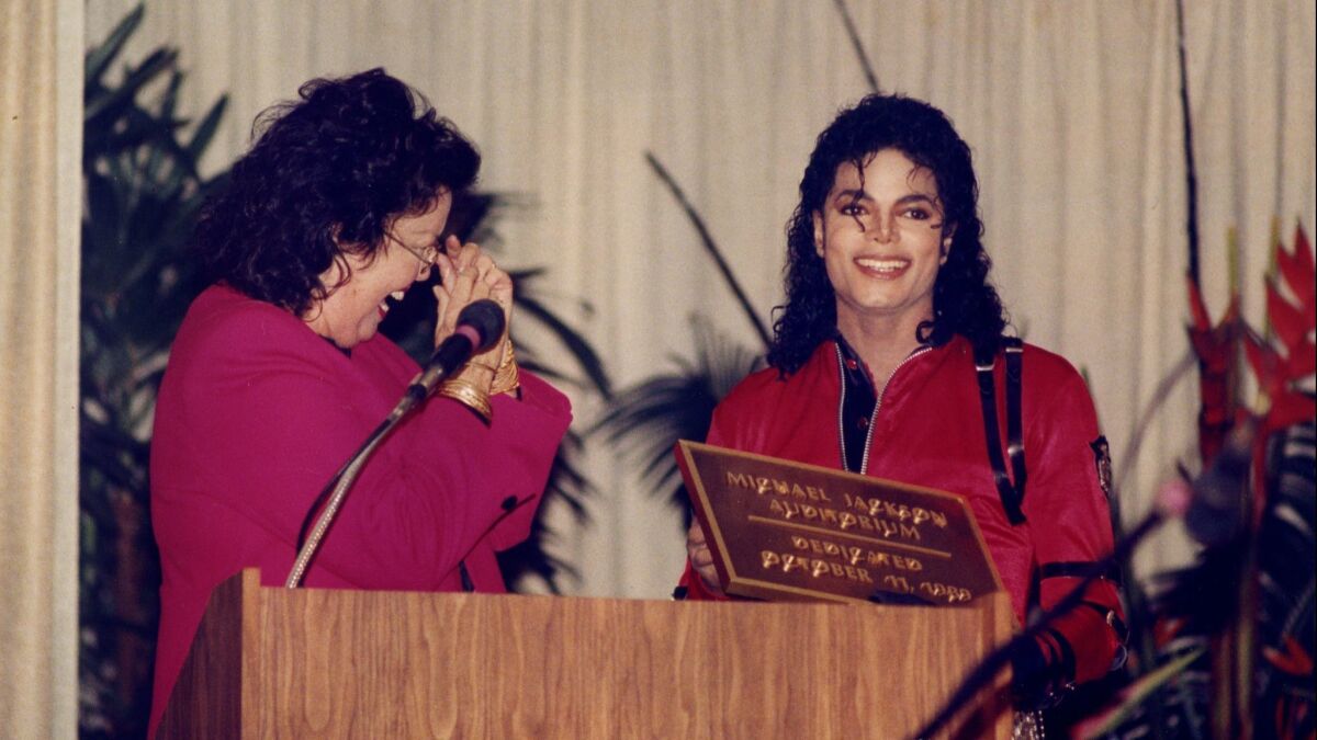 In this photo from 1989, Michael Jackson reunites with sixth-grade teacher Laura Gerson during the naming ceremony at Gardner Elementary.