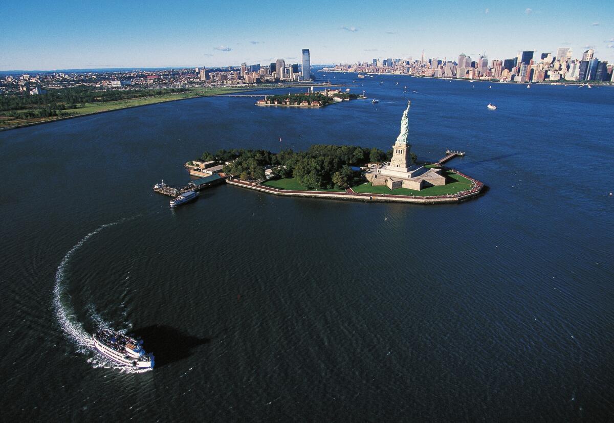 Liberty Island with Ellis Island and Manhattan in the background.