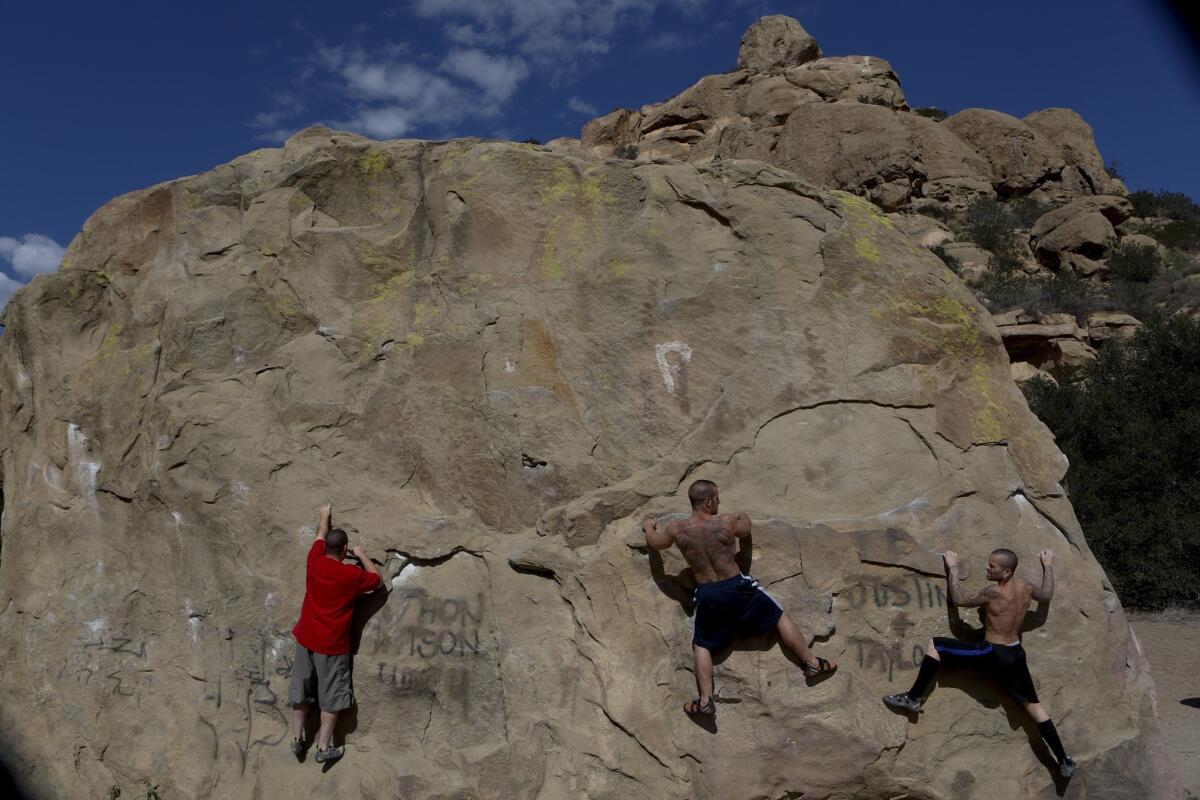 Near the start of the walk, you'll often see climbers on the lower-elevation rocks. Matt Batdorf, left, Danny Varola and Brett Batdorf attempt to scale a rock face.