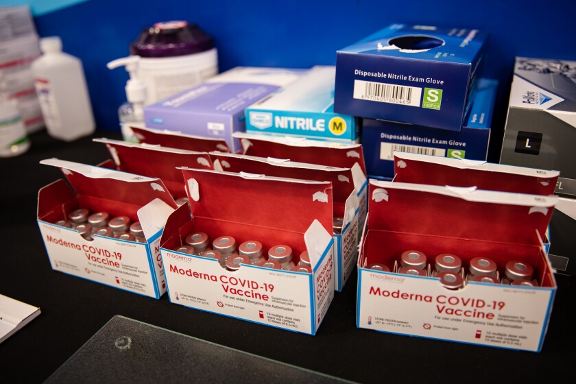 Boxes of Moderna vaccine vials at the CSU San Marcos Clarke Field House, run by Sharp HealthCare. 