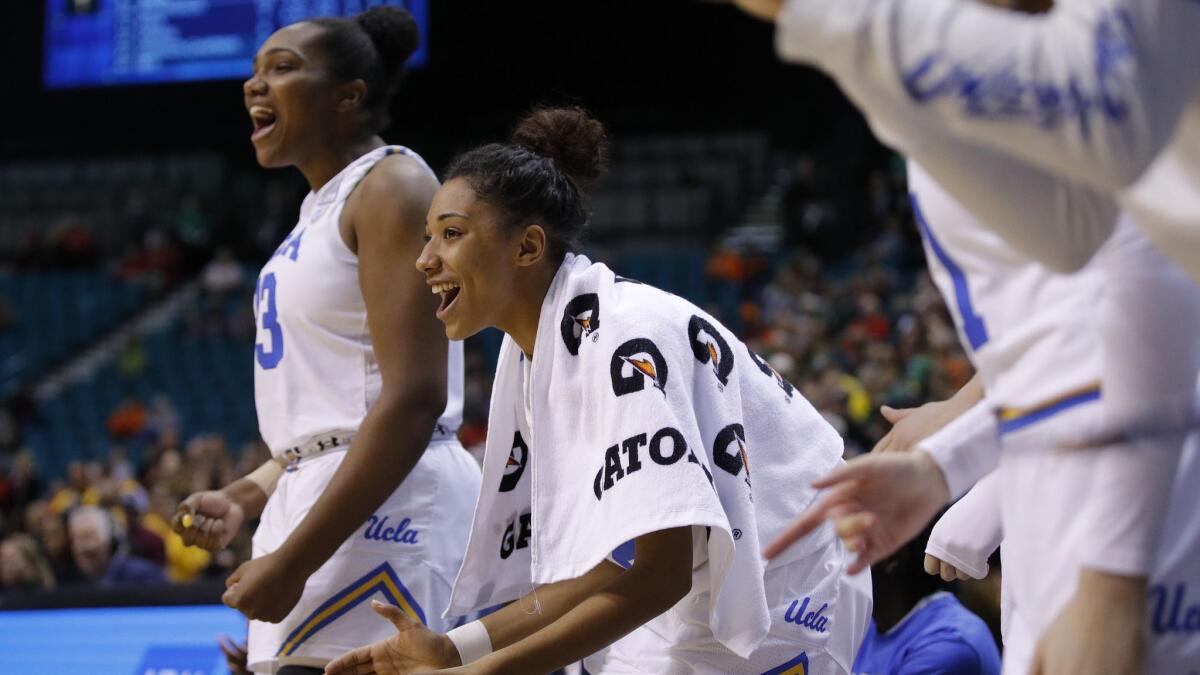 UCLA's Ahlana Smith, center, cheers during the second half against Arizona State at the Pac-12 women's tournament on March 8, 2019, in Las Vegas.