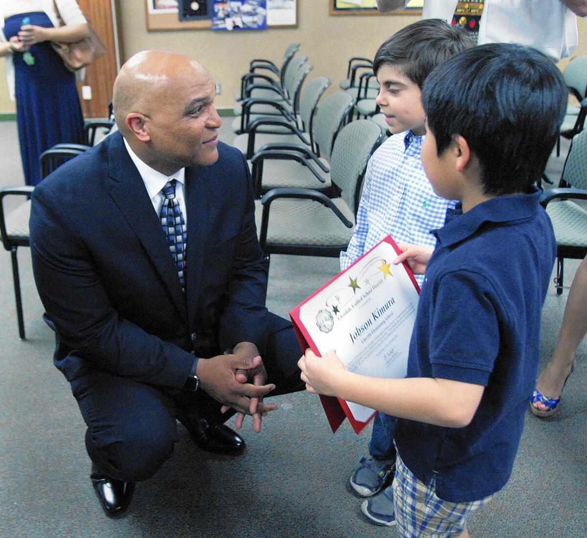Winfred Roberson Jr. speaks with Lincoln Elementary students Peter James, 6, and Jobson Kimura, 7. Roberson was hired by the Glendale Unified School District as its new superintendent Tuesday, Feb. 16, 2016.