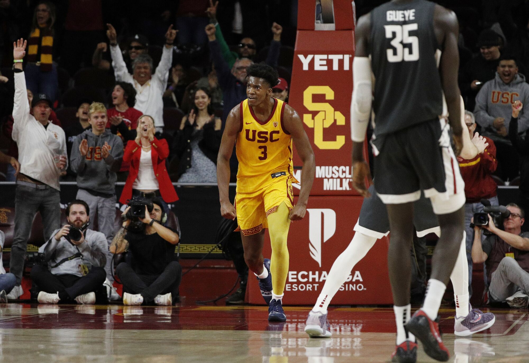 USC forward VIncent Iwuchukwu reacts with the cheering crowd after his slam dunk in the closing moments of the Trojans' win