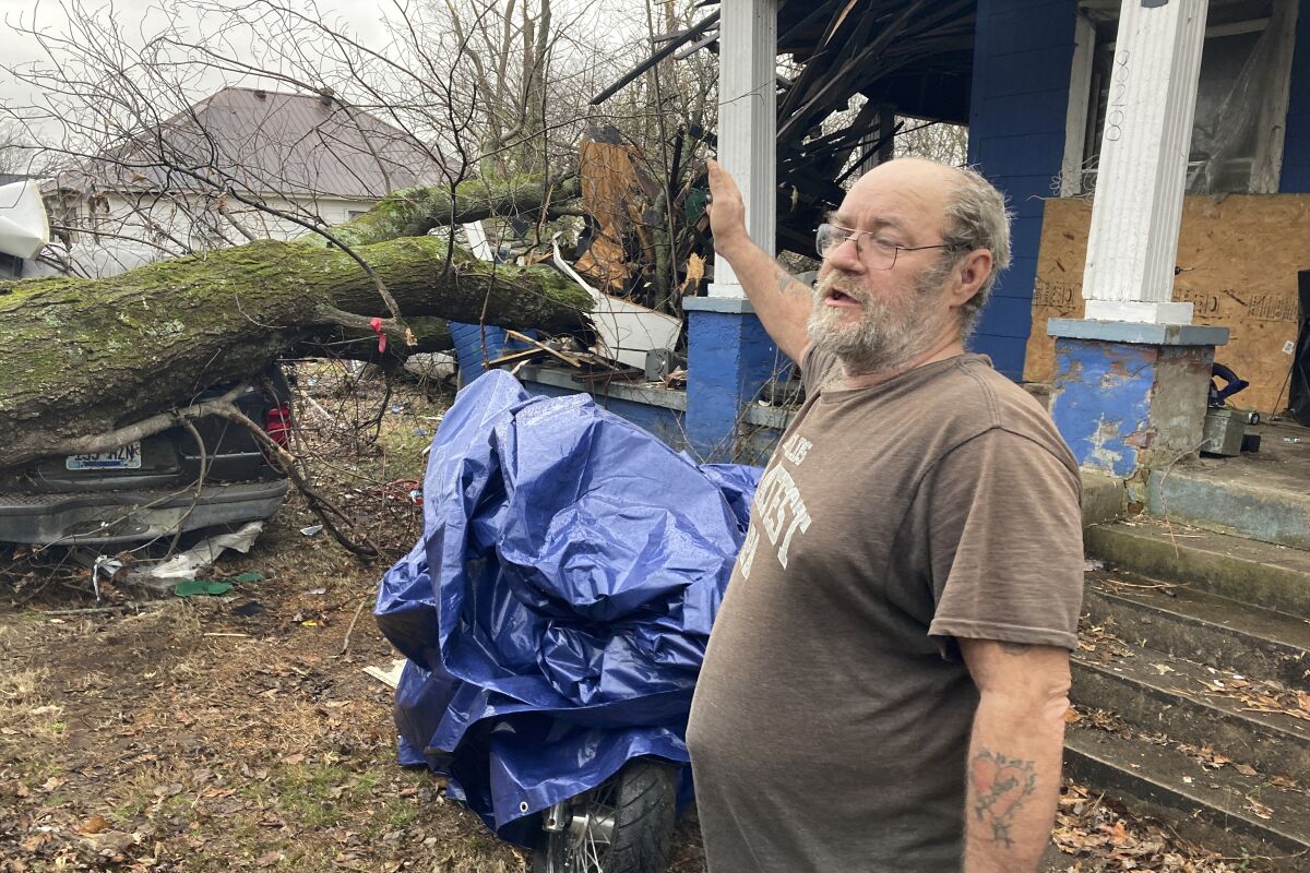 Harley Kelso, 60, speaks while standing outside of his tornado-damaged home in Mayfield, Ky. on Thursday, Dec. 16, 2021. “I lost my car and the corner of my porch," Kelso said. “I'm just glad everyone in the neighborhood survived." (AP Photo/Sean Murphy)