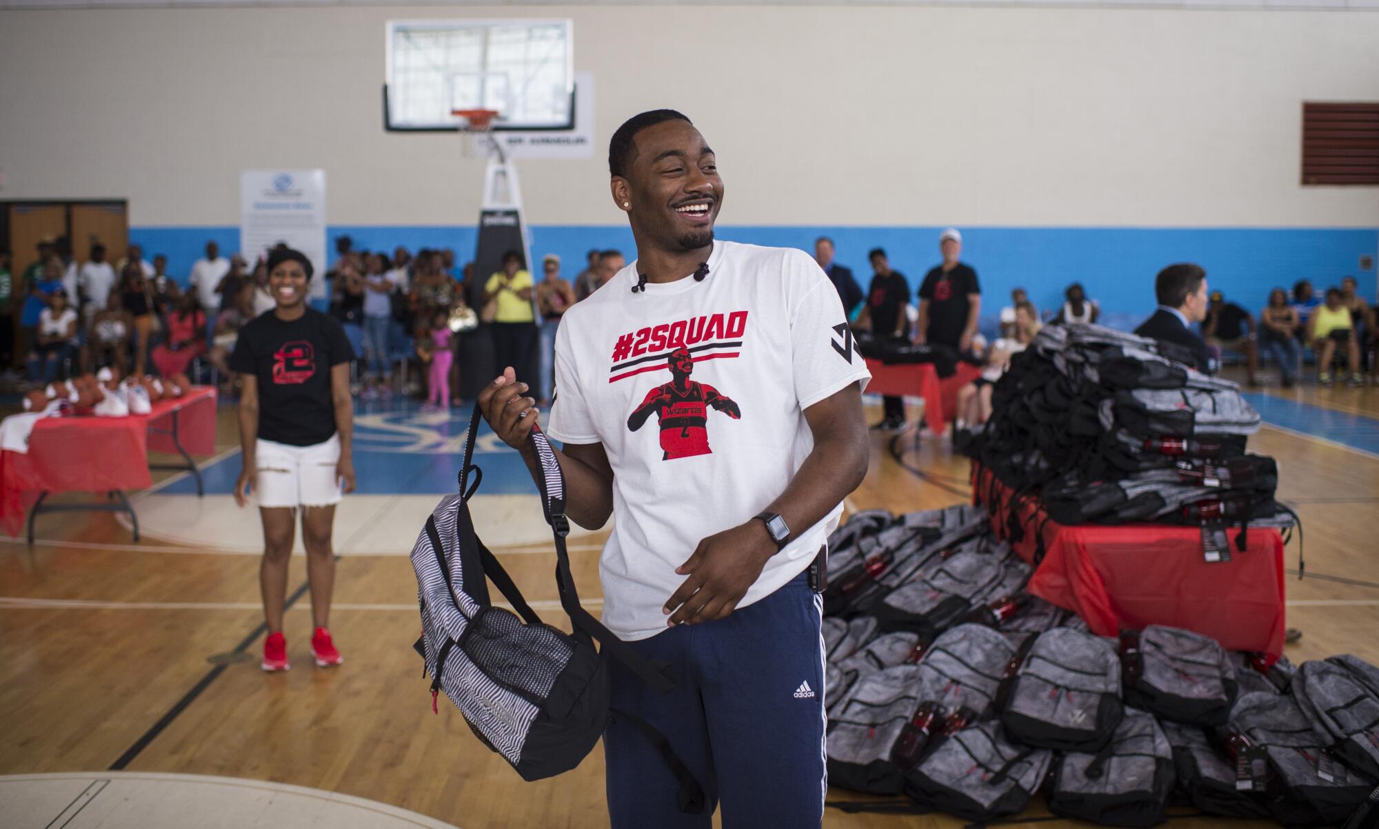 John Wall hands out backpacks full of school supplies to D.C. area students.