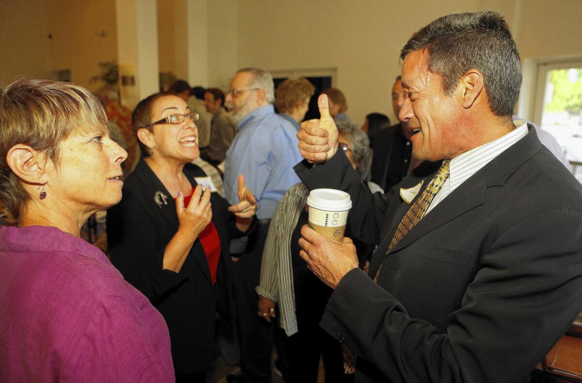 John Duran, right, shown in April, is not known or funded as well as his two top rivals in the supervisor race, Bobby Shriver and Sheila Kuehl.