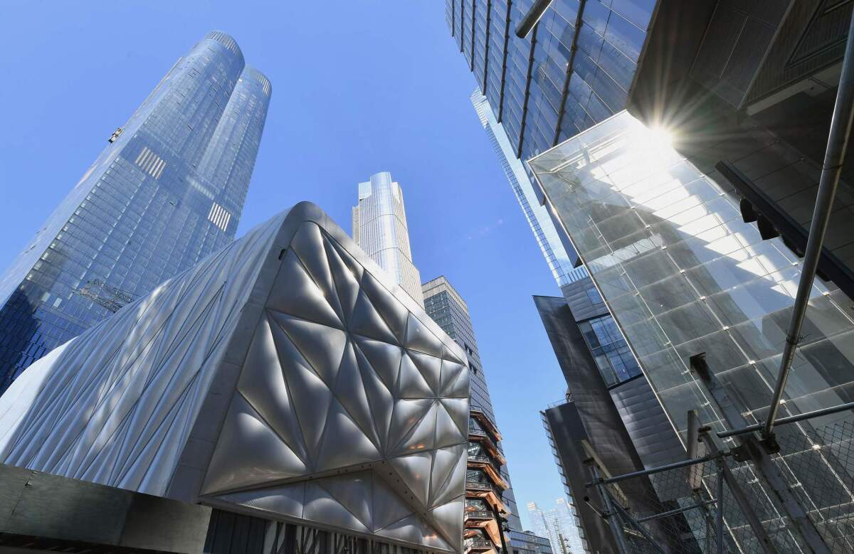 The Shed, with its polymer panels, sits under the towers rising at Hudson Yards.