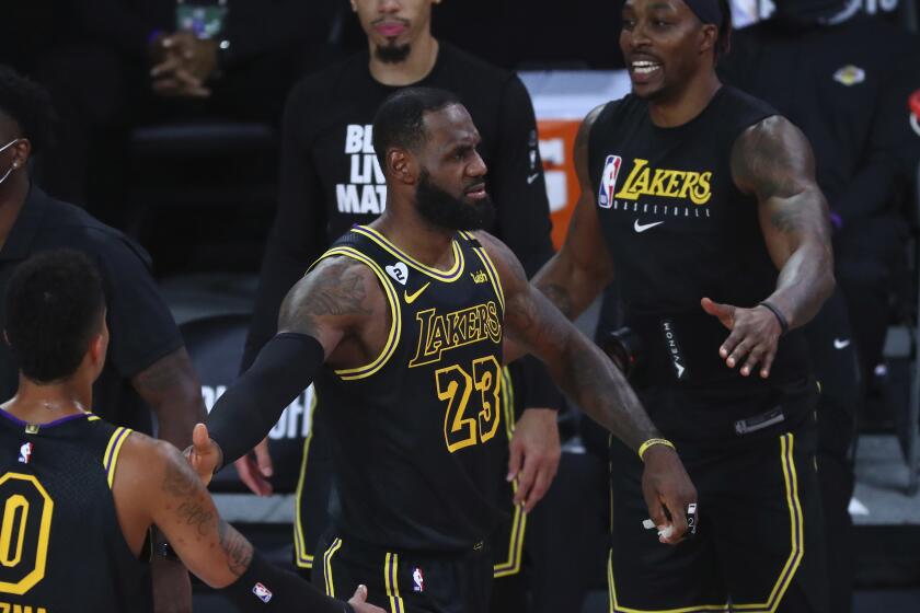 Los Angeles Lakers forward LeBron James (23) reacts with forward Kyle Kuzma (0) in the first half of Game 4.