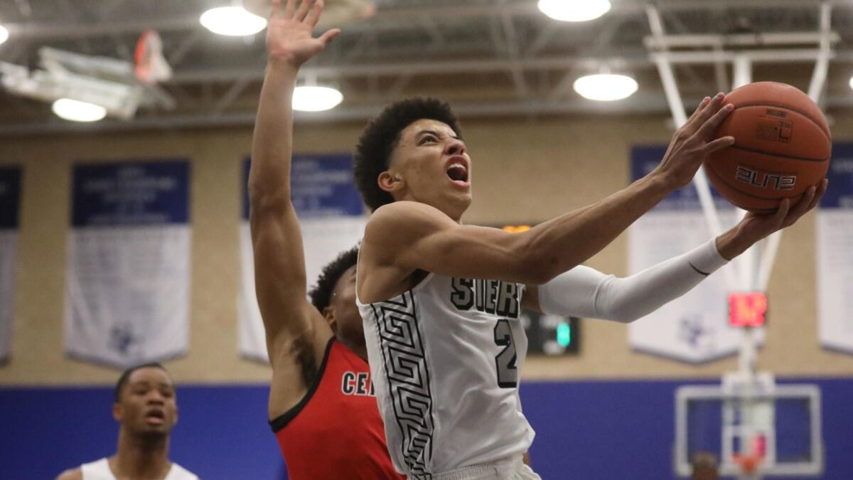 Sierra Canyon's Scotty Pippen, Jr., goes up for two against Centennial's Jaylen Clark at Sierra Canyon gym in Chatsworth on Tuesday.