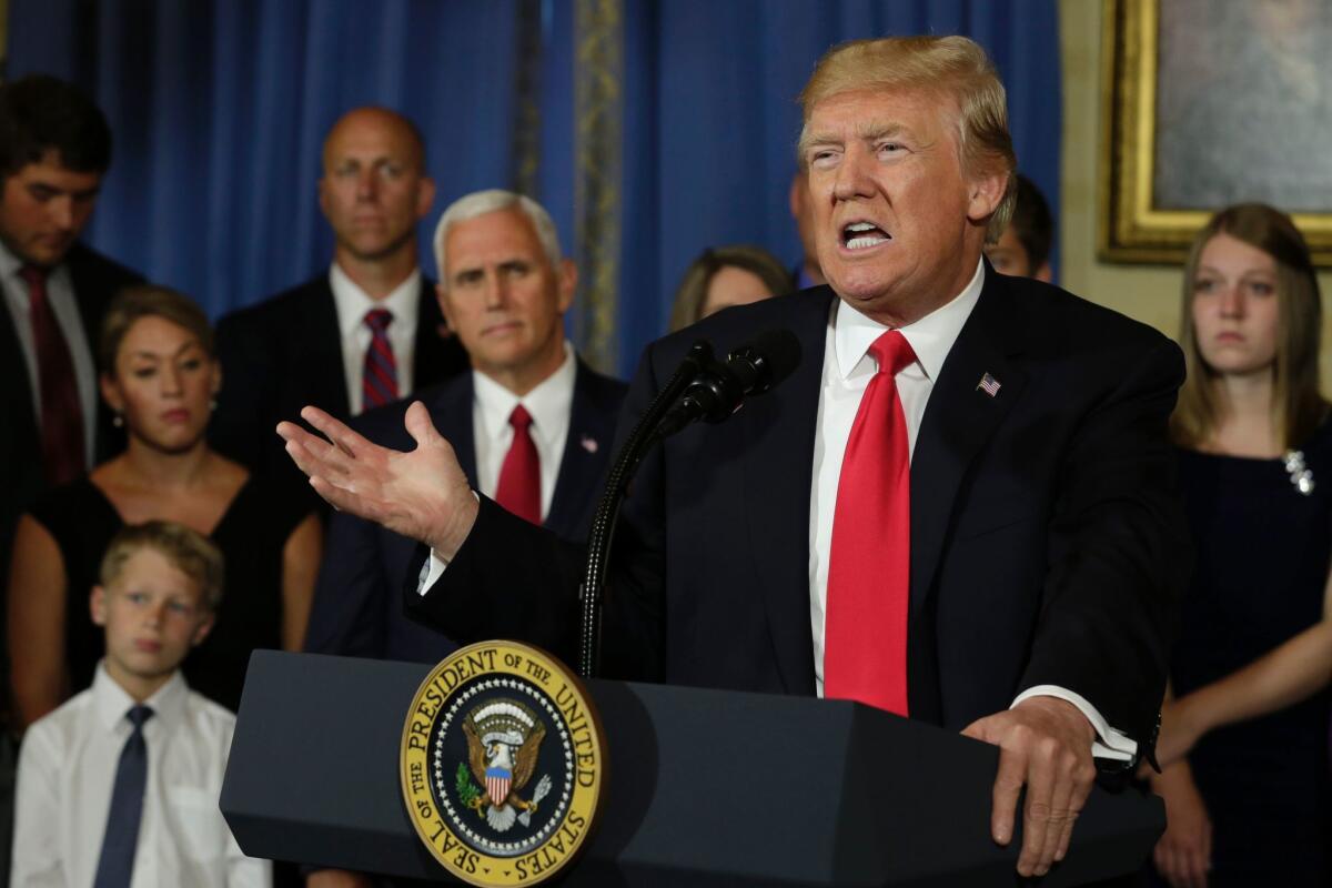 President Trump, accompanied by people who the White House said had been financially harmed by Obamacare, delivers a statement at the White House on July 24.