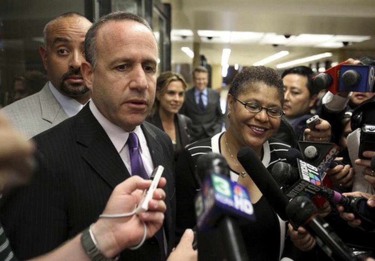 Senate leader Darrell Steinberg and Assembly Speaker Karen Bass talk with reporters as they head to a budget meeting Wednesday. Bass recently accused the governor of moving the goal posts.