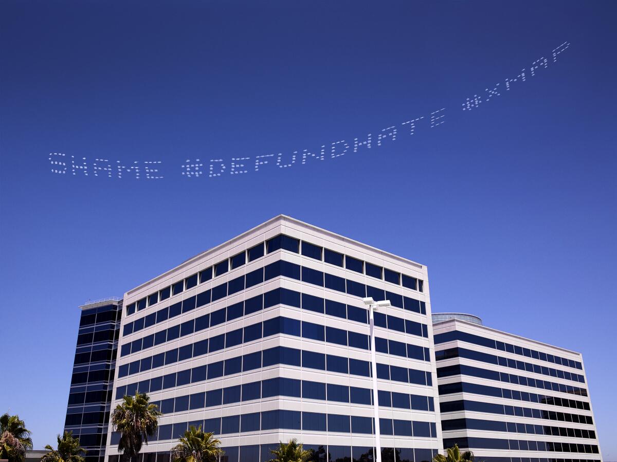 "SHAME #DEFUNDHATE," a message by Cassils over the Geo Group Headquarters, a private prisons firm, in L.A.
