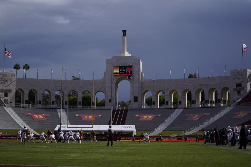 Rain clouds move through the area of Los Angeles Memorial Coliseum during the first half of an NCAA football game between Arizona State and Southern California Saturday, Nov. 7, 2020, in Los Angeles. (AP Photo/Ashley Landis)