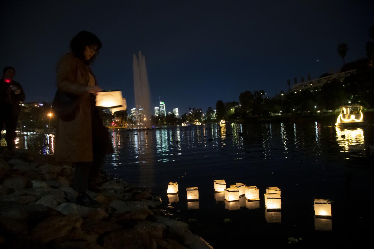 In Echo Lake Park, homeless advocates place floating candles containing the names of homeless people who have died.