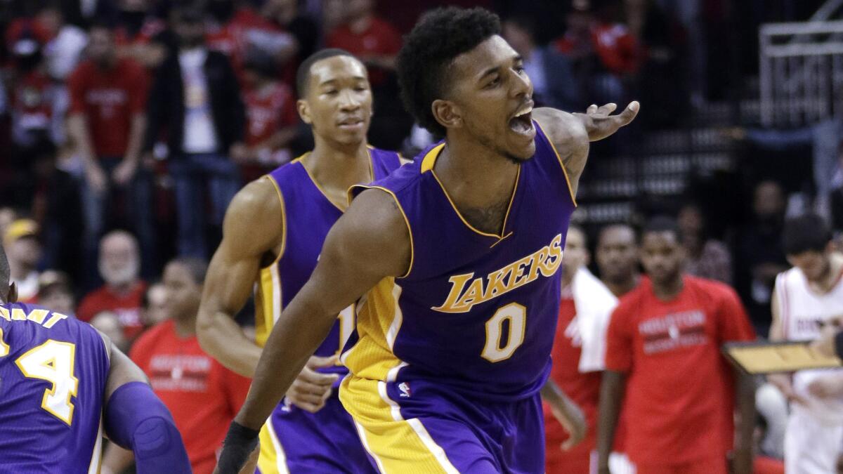 Lakers forward Nick Young celebrates after hitting two free throws in the closing seconds of a 98-92 win over the Houston Rockets on Wednesday.