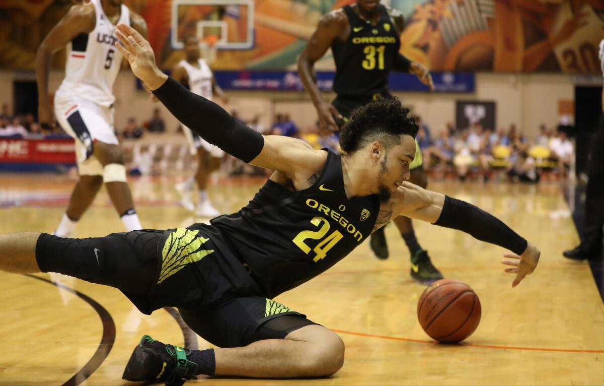 Oregon forward Dillon Brooks (24) dives for a loose ball during the first half of a game against Connecticut in the Maui Invitational on Nov. 23.