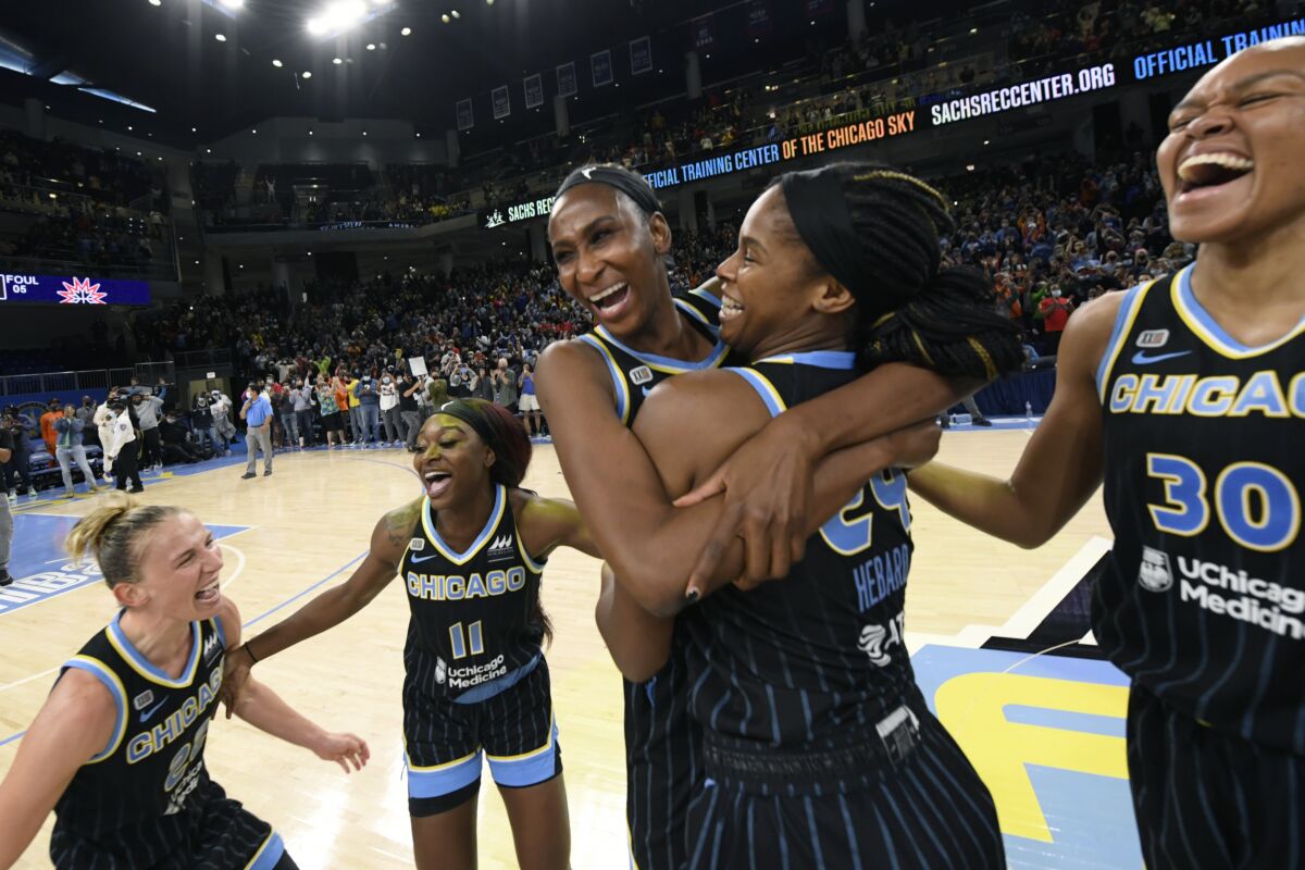 Chicago Sky players celebrate after defeating the Connecticut Sun 79-69 in Game 4 of a WNBA basketball playoff semifinal, Wednesday, Oct. 6, 2021, in Chicago. (AP Photo/Paul Beaty)