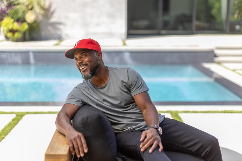 Former Phillies shortstop Jimmy Rollins sits on his patio near his pool in Encino.