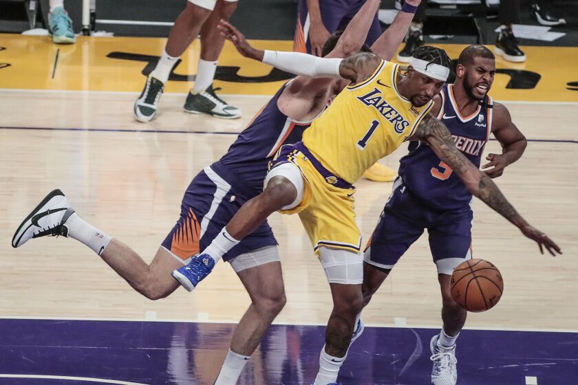 Lakers' Kentavious Caldwell-Pope is stripped of the ball by Phoenix Suns' Chris Paul as he bumps into Dario Saric