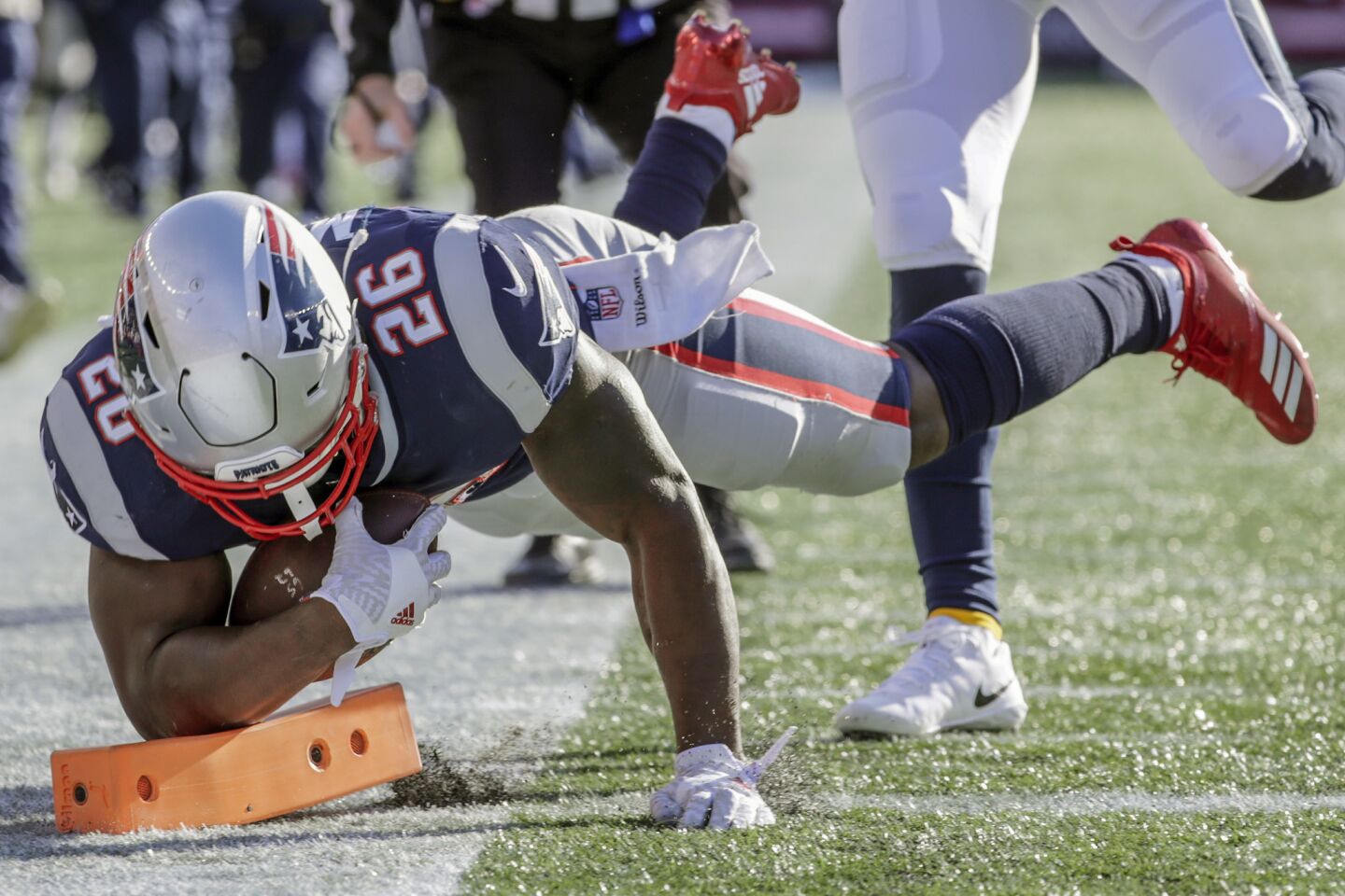 New England Patriots running back Sony Michel dives in for a touchdown early in the first quarter against the Chargers in the NFL AFC Divisional Playoff at Gillette Stadium on Sunday.