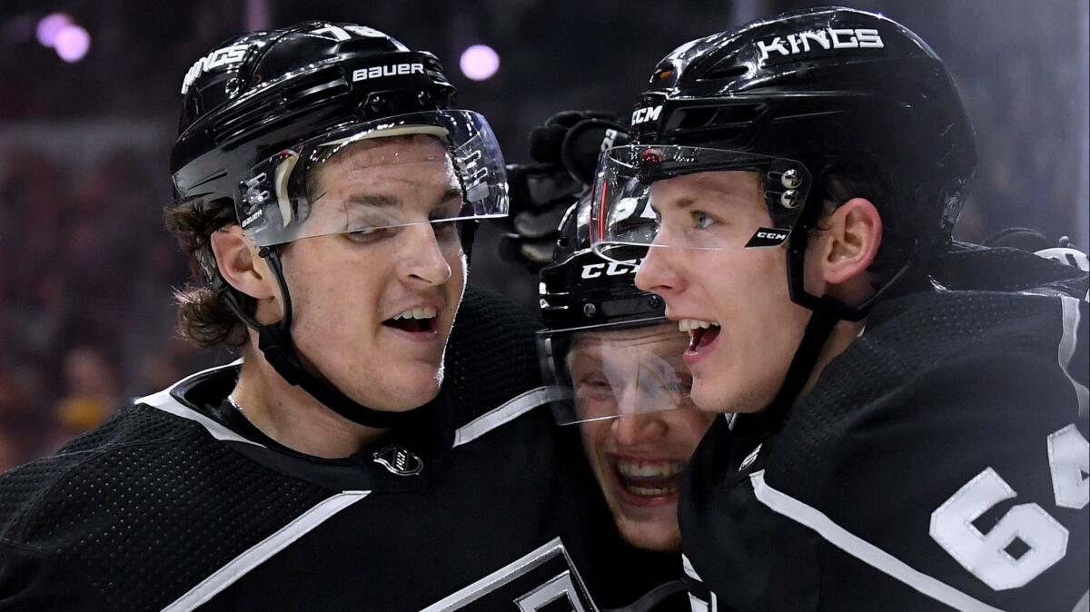 Austin Wagner, left, celebrates his second goal of the game with Matt Luff (64) and Daniel Brickley.