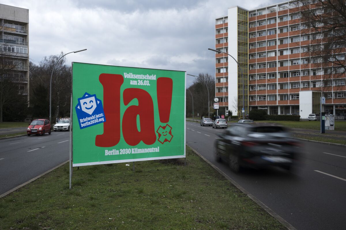 A poster with a huge "Yes", advertising a climate referendum stands out along a street in Berlin, Friday, March 24, 2023. Voters in Berlin go to the polls this weekend to decide on a proposal that would force the city government to drastically ramp up the German capital’s climate goals. Sunday's referendum, which has attracted considerable financial support from U.S.-based philanthropists, calls for Berlin to become climate neutral by 2030, meaning that within less than eight years the city would not be allowed to contribute further to global warming. (AP Photo/Markus Schreiber)
