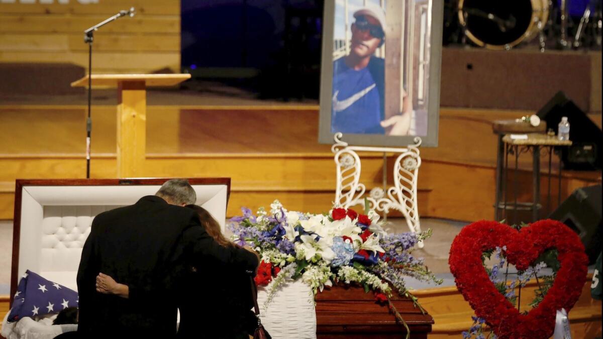Mourners embrace in front of Christian Riley Garcia’s casket during a funeral service on Friday in Crosby, Texas. The 15-year-old Santa Fe High School student was one of 10 students and staff slain in a mass shooting at the school on May 18.
