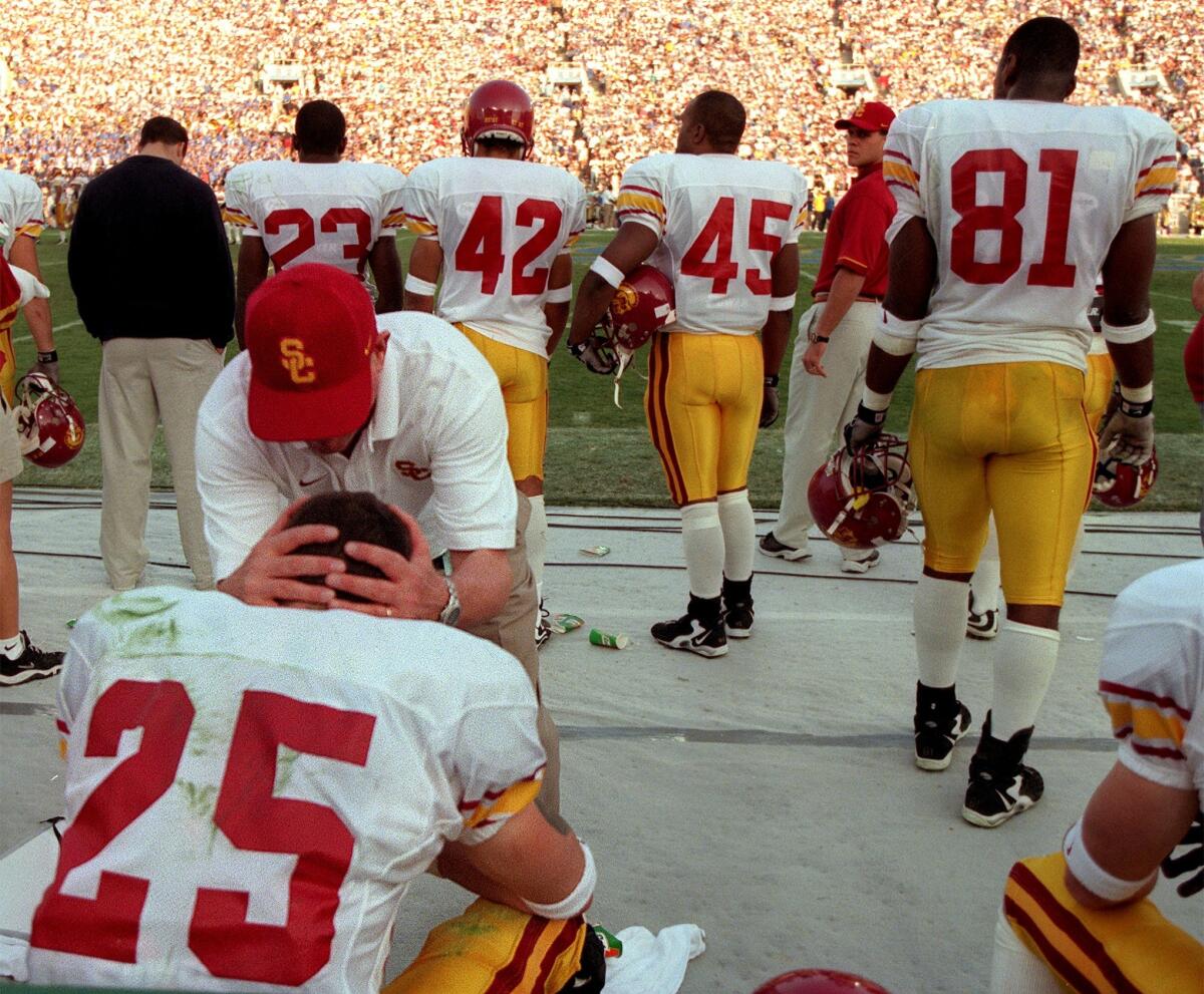 USC coach Paul Hackett consoles Trojans wide receiver Brian Bastianelli after Bastianelli dropped a sure touchdown pass late in the fourth quarter of USC's 3417 loss to the Bruins at the Rose Bowl on Nov. 21, 1998.