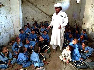 Merajuddin Shinvari teaches boys at a primary school established at the camp by the U.N. High Commissioner for Refugees.