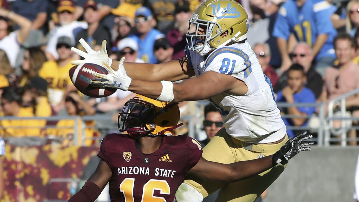UCLA tight end Caleb Wilson leaps to catch a pass over Arizona State defensive back Aashari Crosswell during the second half. Wilson had season highs with 11 receptions, 164 yards and two touchdowns.