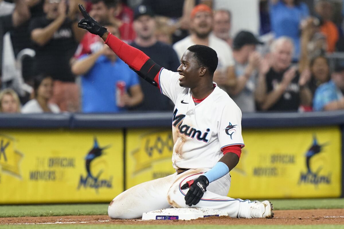 Miami Marlins' Jesus Sanchez reacts after hitting a triple against the Philadelphia Phillies during the fourth inning of a baseball game Thursday, April 14, 2022, in Miami. (AP Photo/Lynne Sladky)
