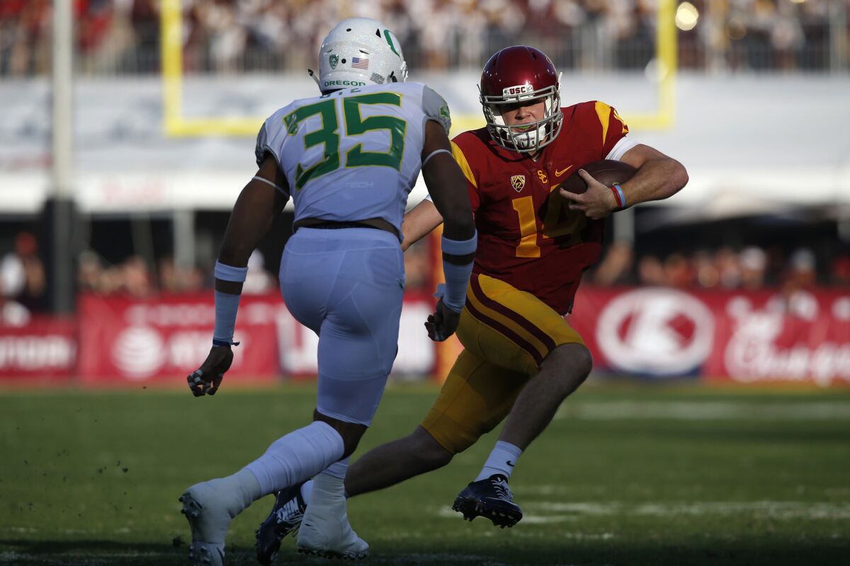 USC quarterback Sam Darnold scrambles away from Oregon linebacker Troy Dye during the first quarter on Nov. 5.