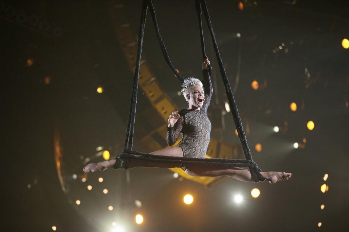 Will Pink, shown at the 2014 Grammy Awards, bring her acrobatic ways to the Oscars?
