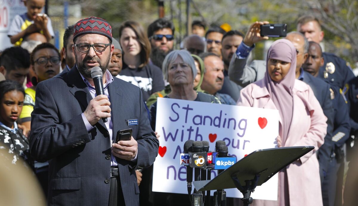 Imam Taha Hassane, left, of the Islamic Center of San Diego in Clairemont speaks at a news conference organized by the Muslim Leadership Council of San Diego, denouncing hate and the mass shooting at two mosques in New Zealand.