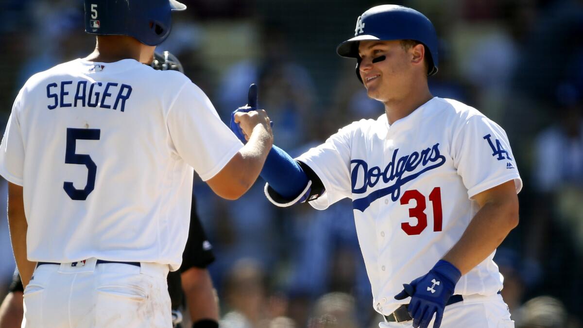 Dodgers center fielder Joc Pederson is congratulated by teammate Corey Seager after hitting a two-run home run against the Pirates in the sixth inning last Saturday.