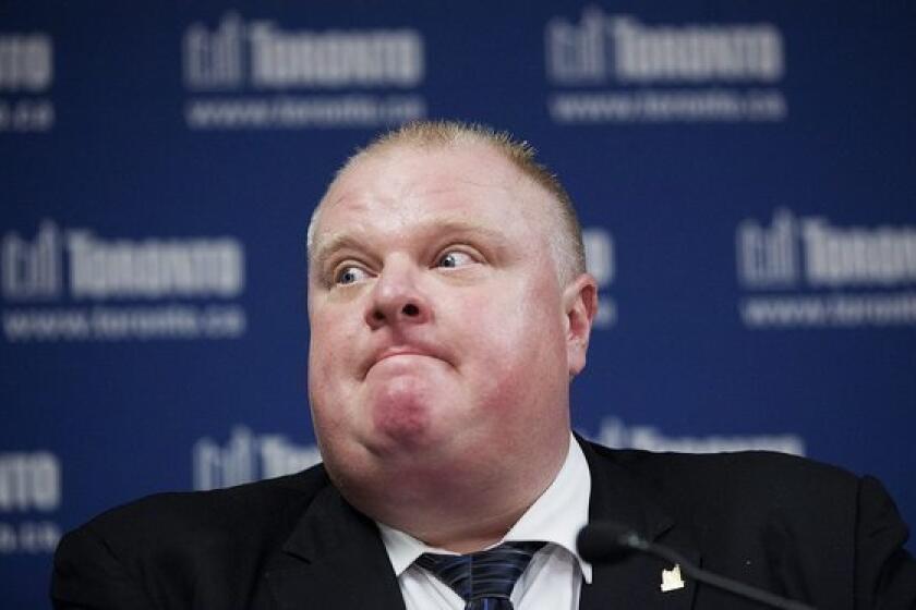 Toronto Mayor Rob Ford answers questions about staff changes at at city hall during a news conference Friday.