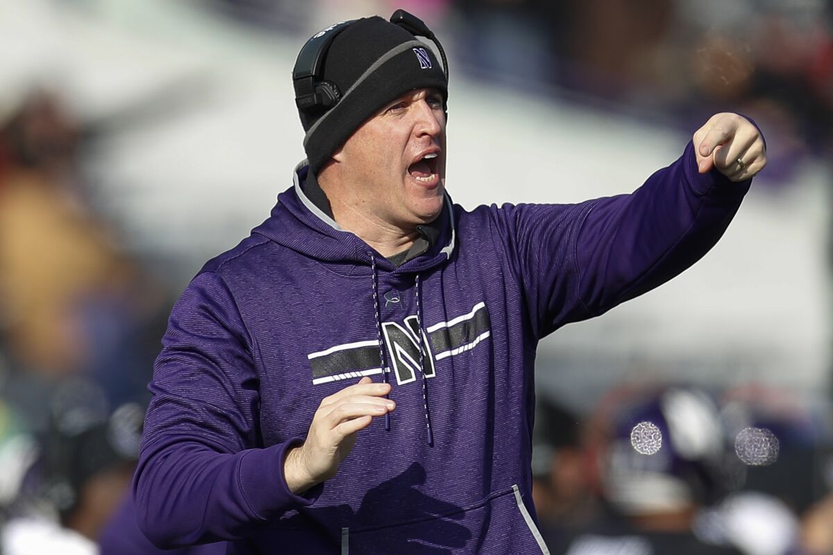 FILE - In this Saturday, Nov. 16, 2019, file photo, Northwestern coach Pat Fitzgerald calls out a play during the first half of an NCAA college football game against Massachusetts, in Evanston, Ill. Northwestern underwent quite a transformation last season, and it sure wasn't the kind the Wildcats welcomed. They became the first team to go from playing in the Big Ten championship game to finishing last in the division the following year. They're looking for a quick turnaround. (AP Photo/Jim Young, File)