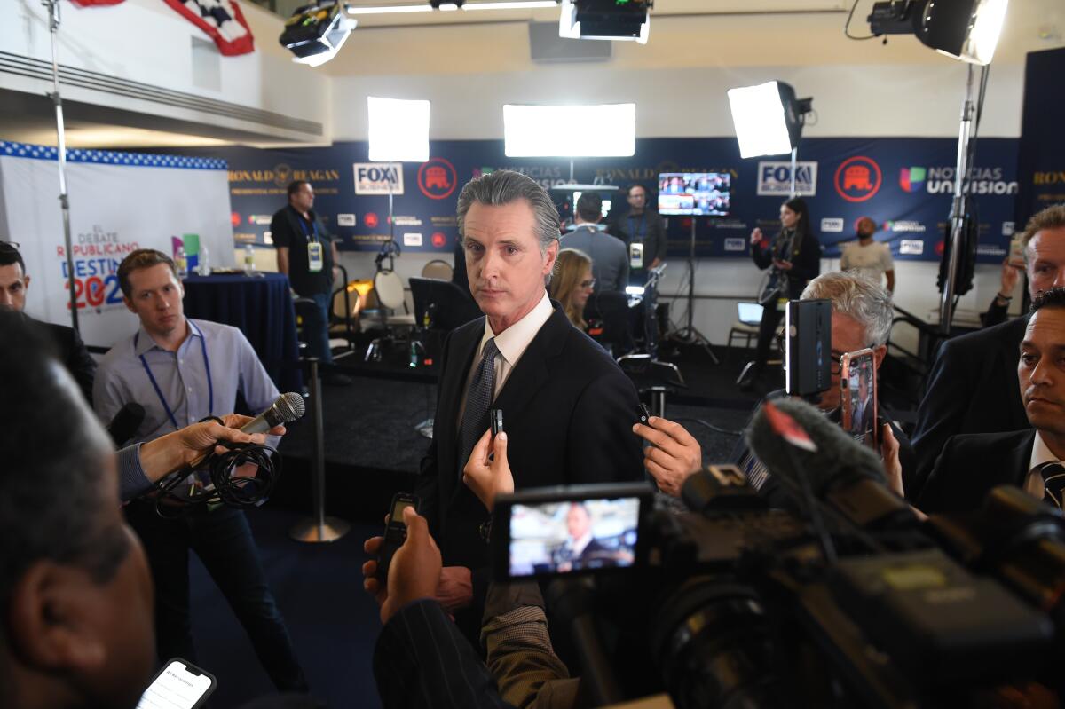 California Gov. Gavin Newsom is shown in the spin room at a GOP presidential debate.