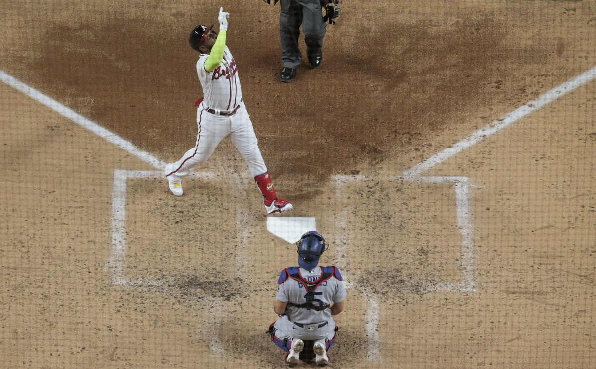 Atlanta Braves designated hitter Marcell Ozuna celebrates as he crosses home plate.