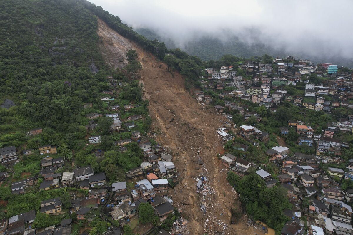 A view of a mudflow down a hillside packed with homes
