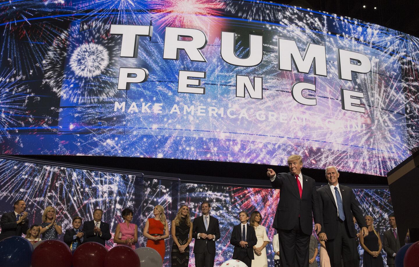 With their families behind them, Republican Presidential nominee Donald Trump and Vice Presidential nominee Mike Pence are cheered on by delegates at the close of the final day of the 2016 Republican National Convention in Cleveland.