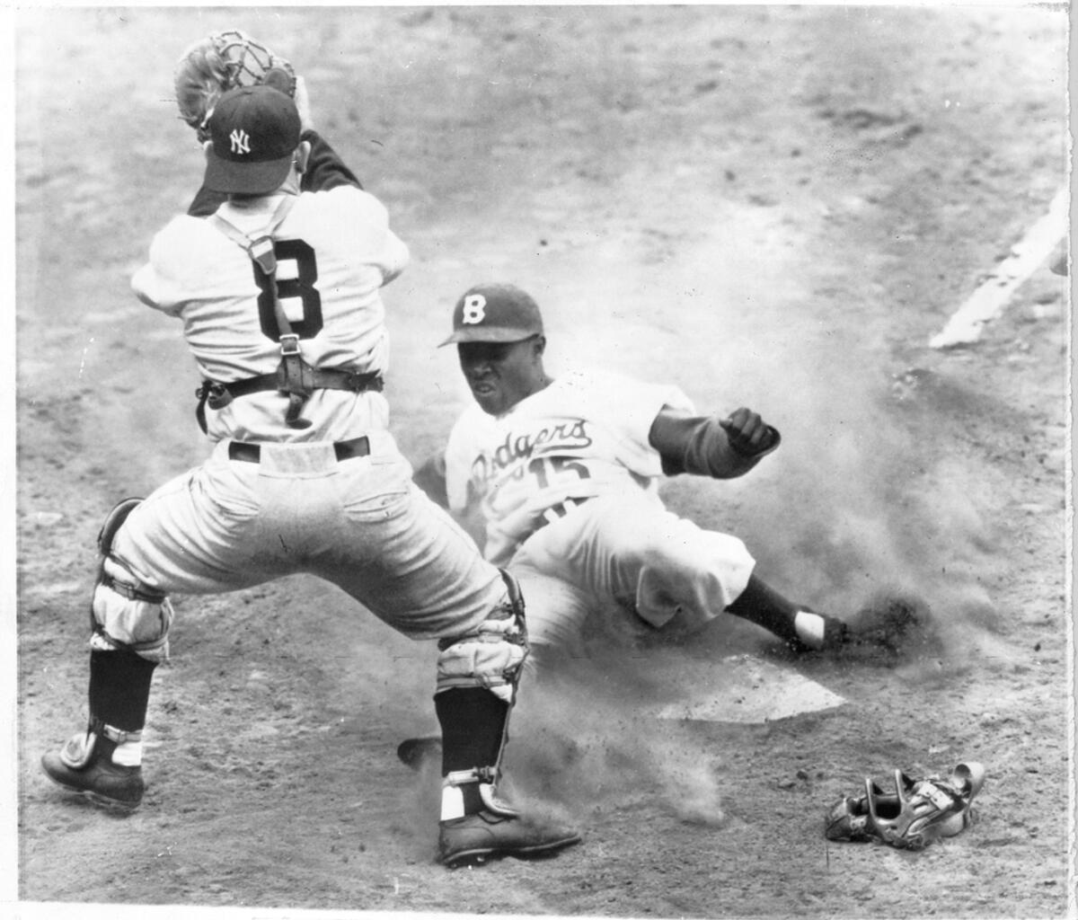 Sandy Amoros sliding into a waiting Yogi Berra to score in the 1955 World Series.
